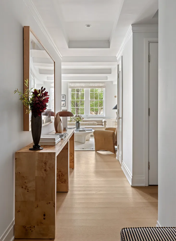 a living room with furniture a window and a table
