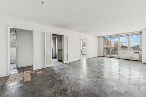 a view of a livingroom with furniture and an empty room