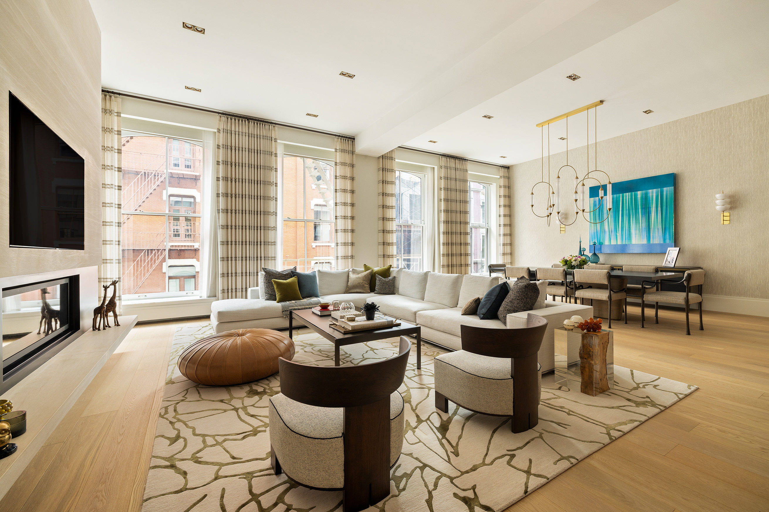53 Greene Street, Unit 3 Manhattan, NY 10013 - Photo 2 of 22 a living room with furniture fireplace and a flat screen tv