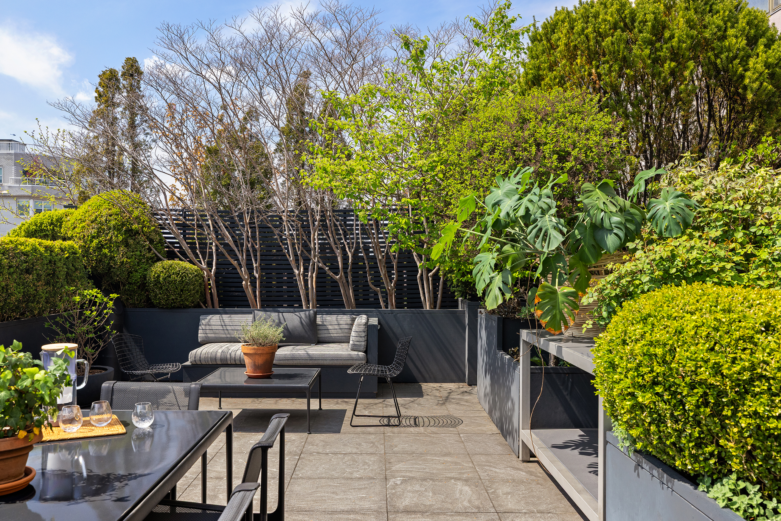 65 West 13th Street, Unit PHD Manhattan, NY 10011 - Photo 15 of 45 a patio with table and chairs and potted plants