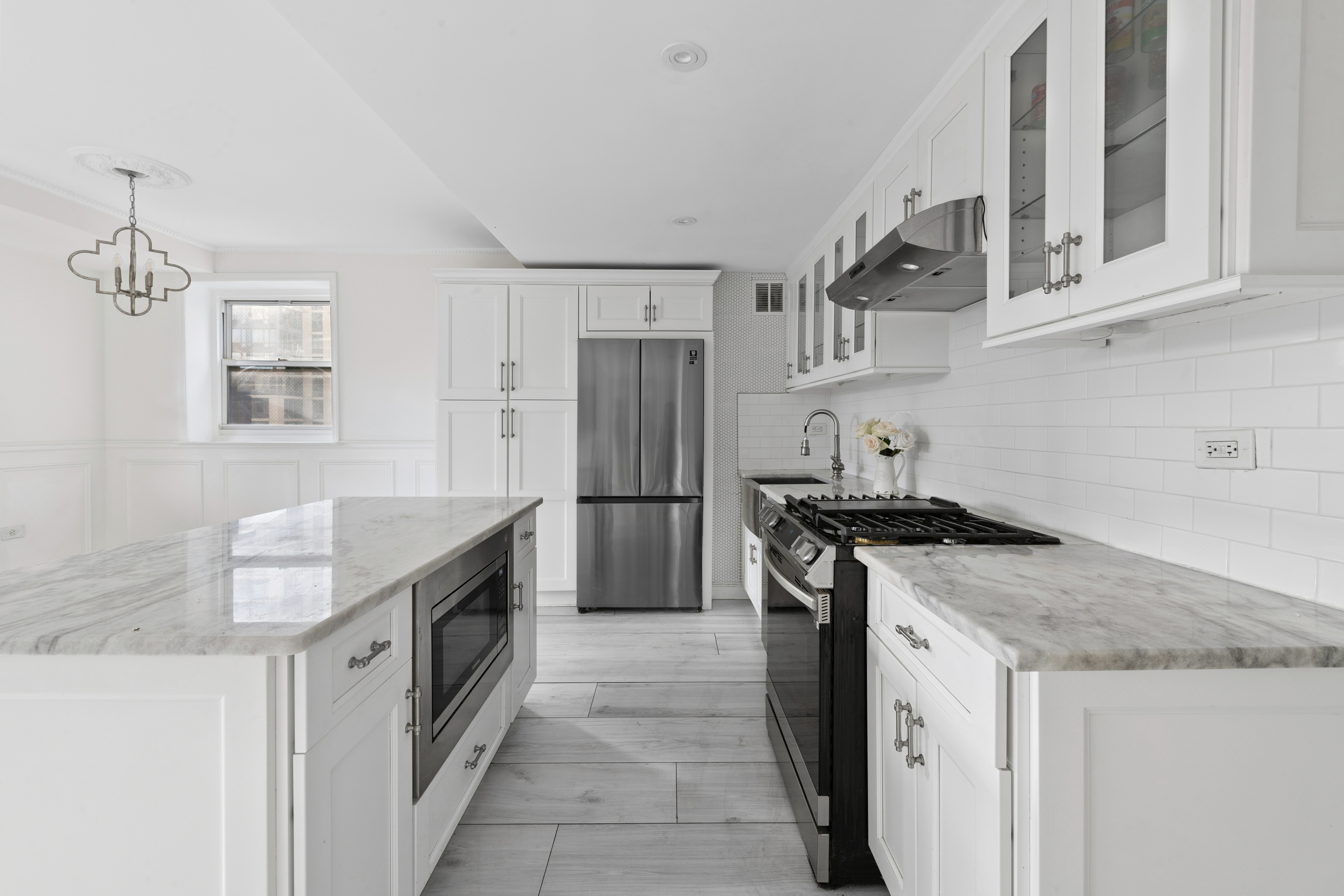 350 East 62nd Street, Unit PHD Manhattan, NY 10065 - Photo 4 of 15 a kitchen with stainless steel appliances granite countertop a stove and a sink