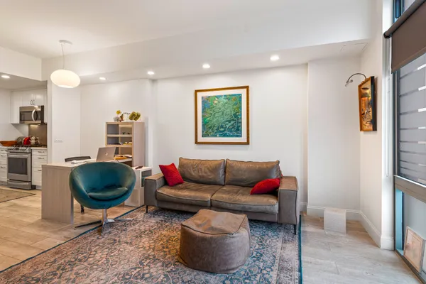a living room with furniture a rug and a chandelier