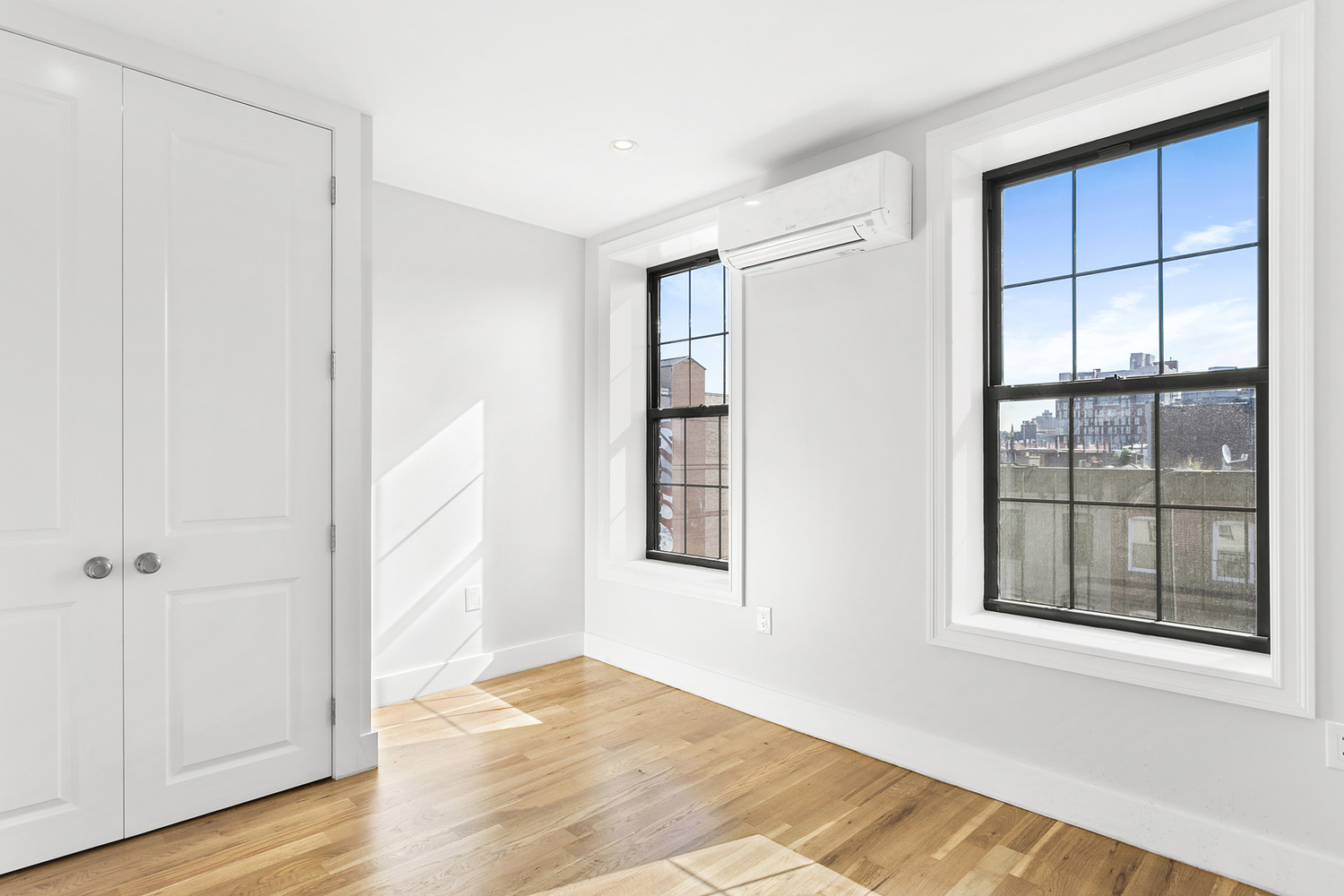 276 3rd Avenue, Unit 4A Brooklyn, NY 11215 - Photo 3 of 6 a view of an empty room with wooden floor and a window