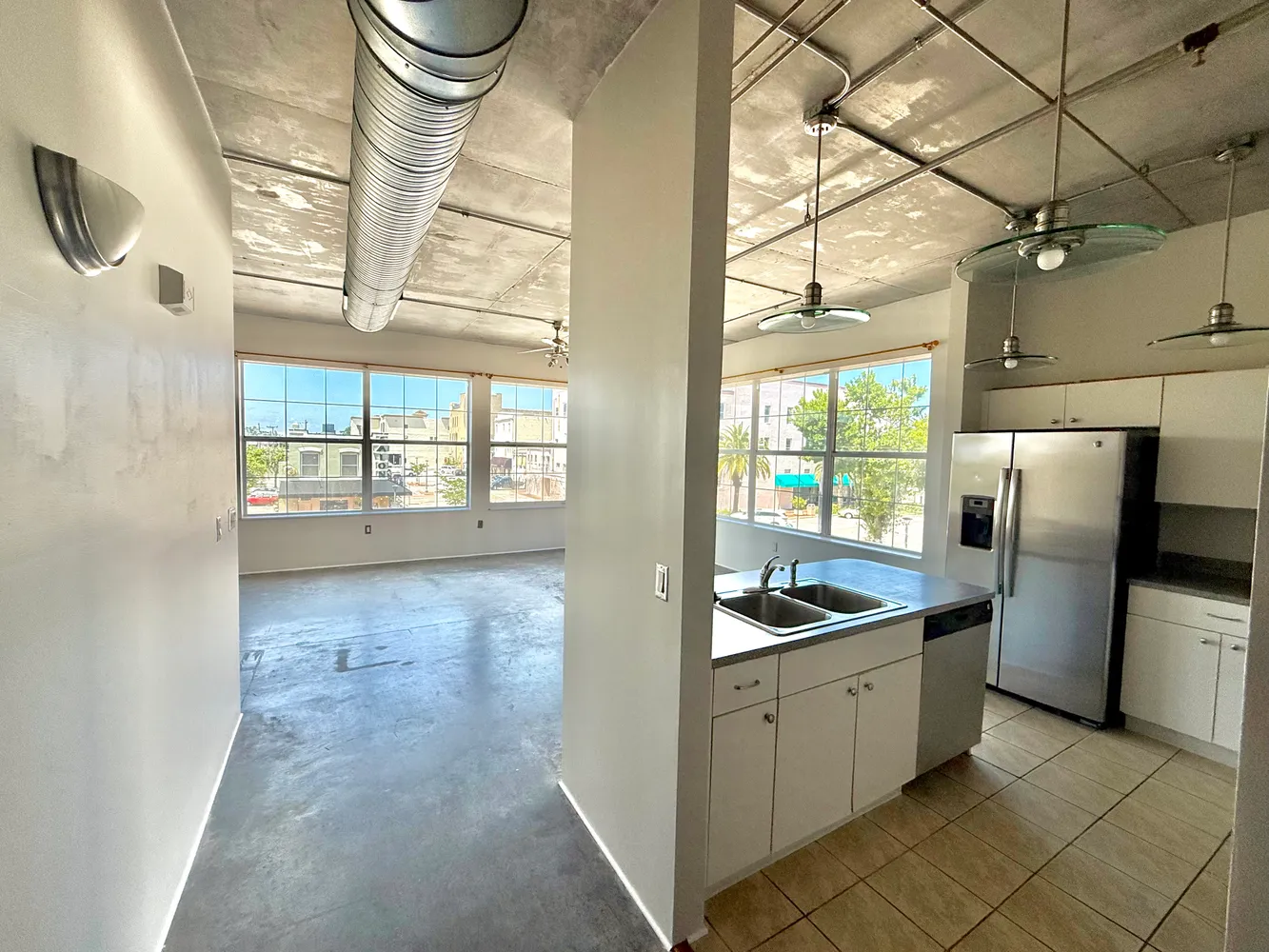 a kitchen with granite countertop a refrigerator and a sink