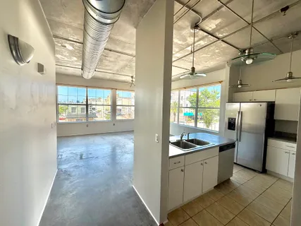 a kitchen with granite countertop a refrigerator and a sink