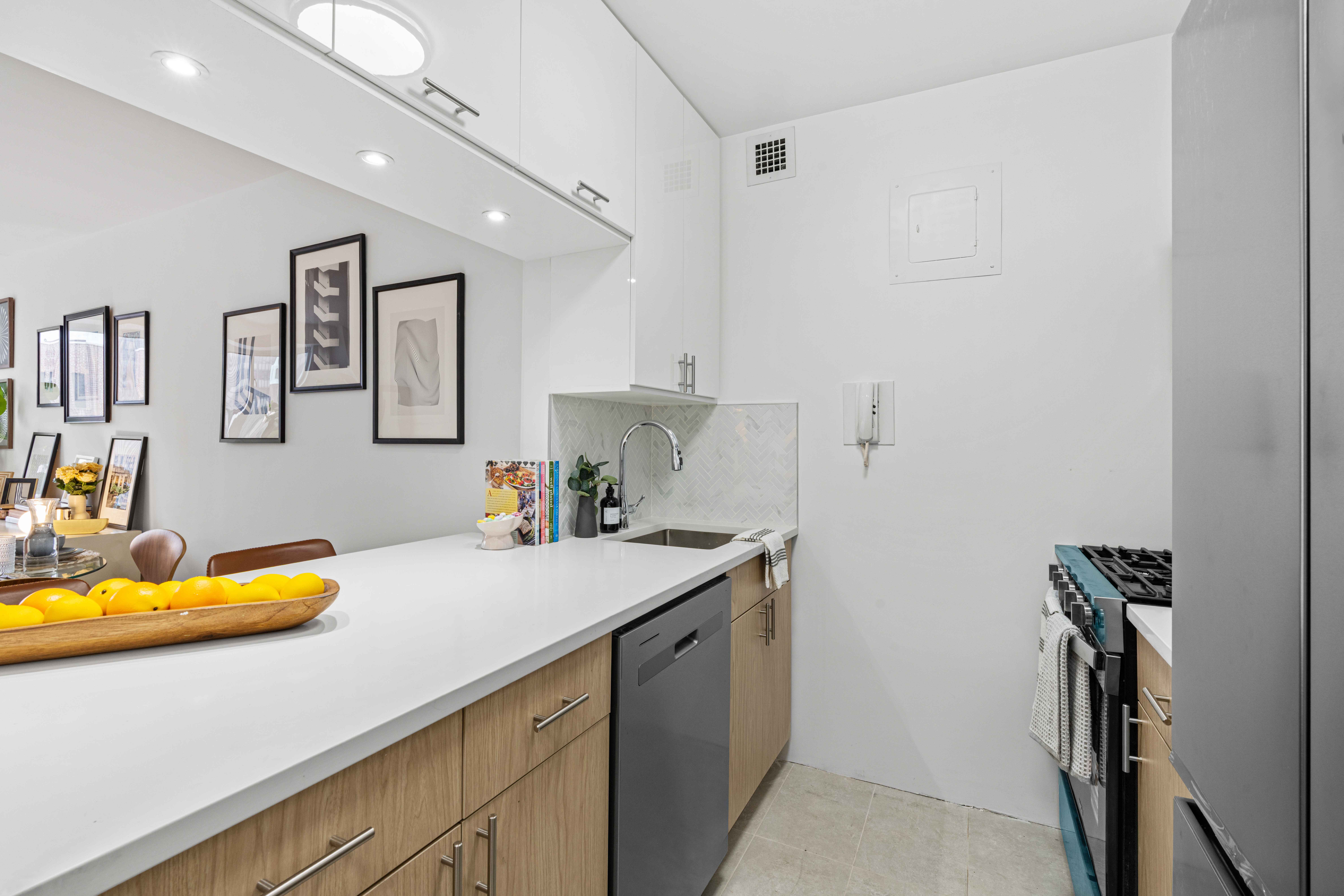 400 East 54th Street, Unit 22D Manhattan, NY 10022 - Photo 7 of 21 a kitchen with a sink appliances and cabinets