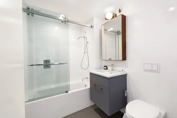 a bathroom with a sink toilet tub and shower