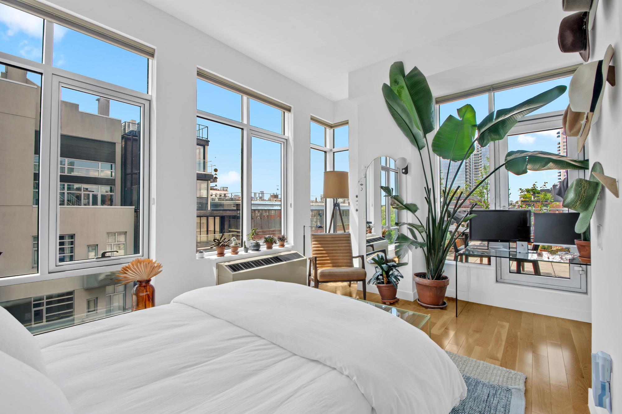101 North 5th Street, Unit 5A Brooklyn, NY 11249 - Photo 13 of 26 a bedroom with a bed a large window and potted plant