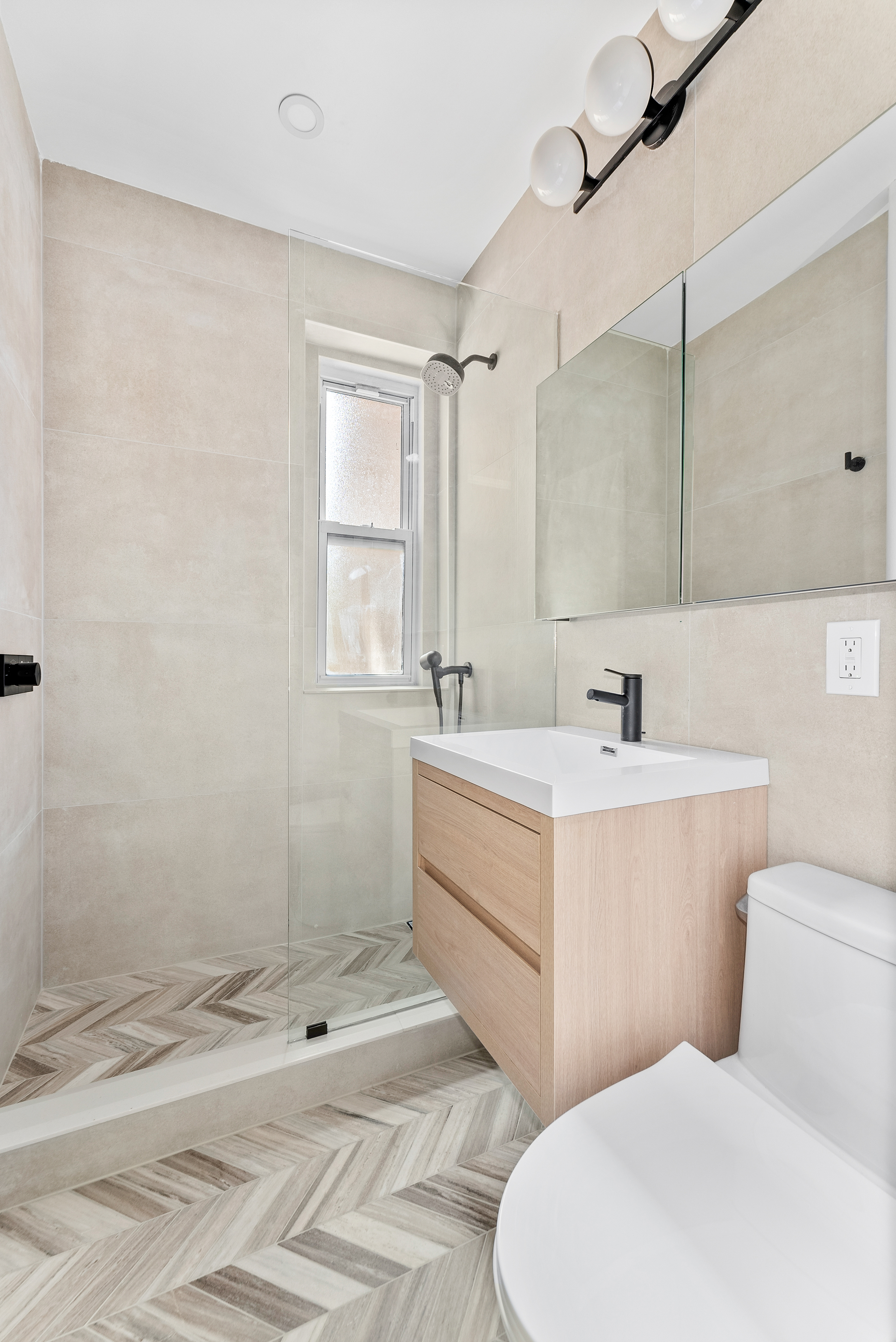 342 West 21st Street, Unit 3E Manhattan, NY 10011 - Photo 6 of 10 a bathroom with a sink mirror vanity and toilet