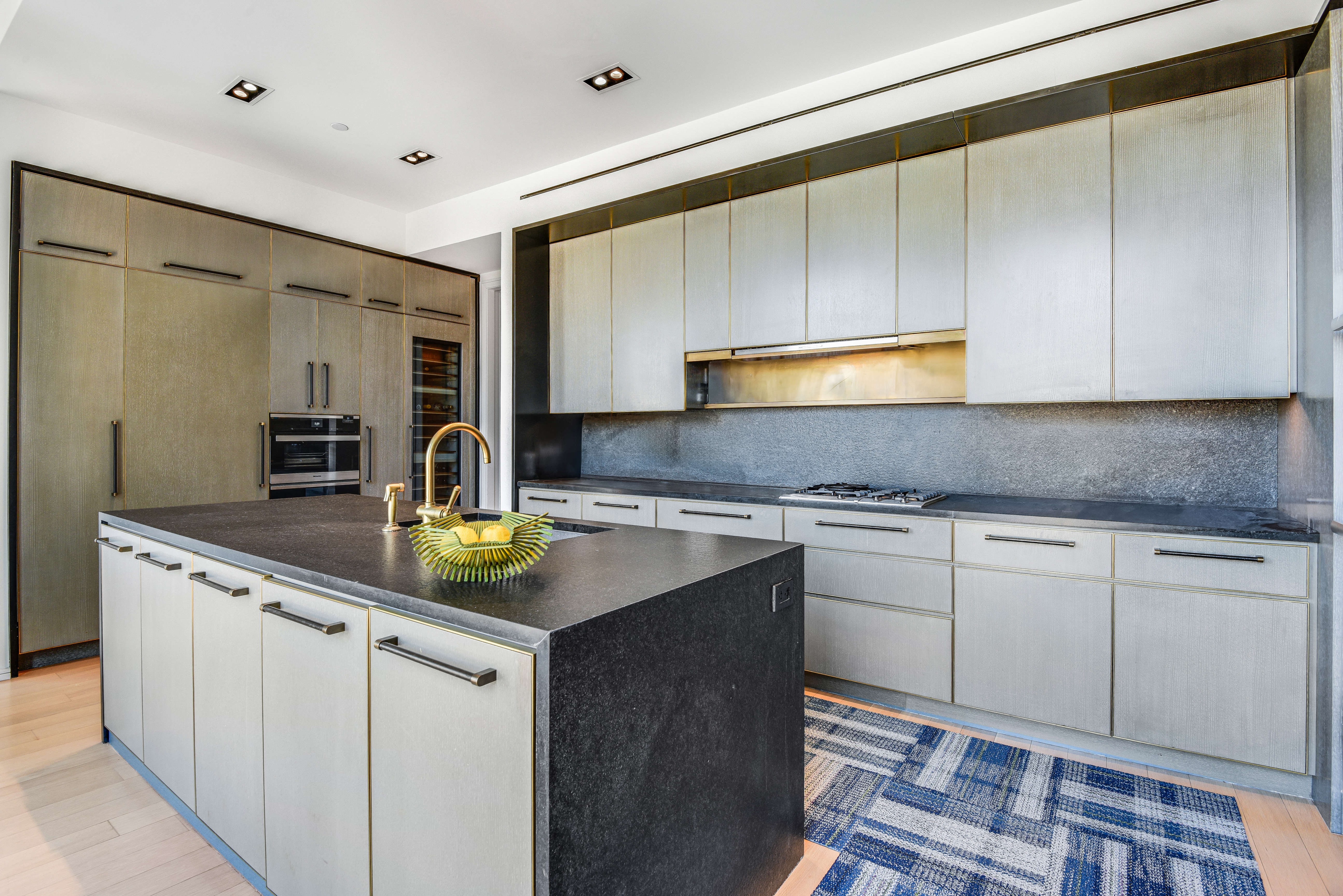 505 West 19th Street, Unit 7W Manhattan, NY 10011 - Photo 10 of 31 a kitchen with stainless steel appliances granite countertop a sink and cabinets