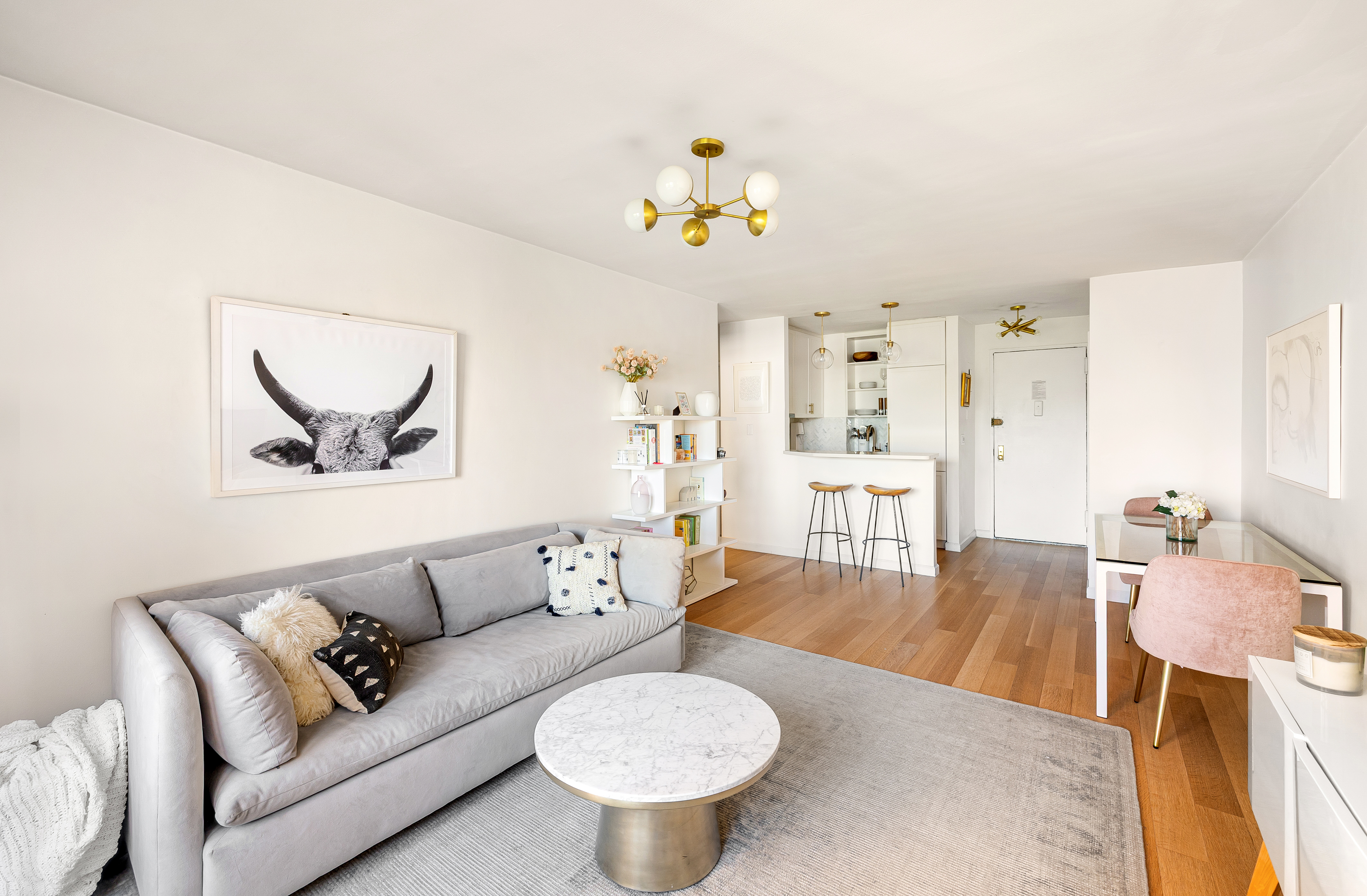 165 Christopher Street, Unit 5DD Manhattan, NY 10014 - Photo 4 of 15 a living room with furniture and a breakfast area