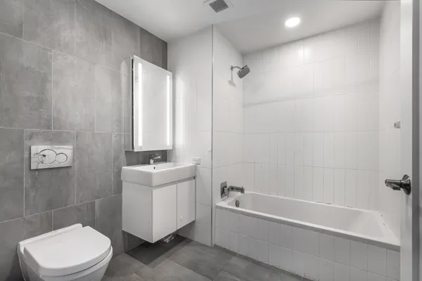 a bathroom with a sink mirror bathtub and toilet