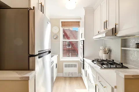 a kitchen with stainless steel appliances a refrigerator and a stove