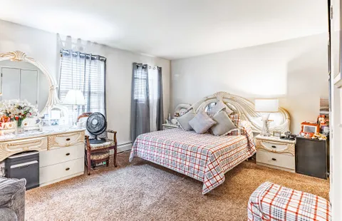 a bedroom with a bed and a dresser