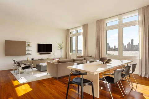 a dining room with furniture and wooden floor