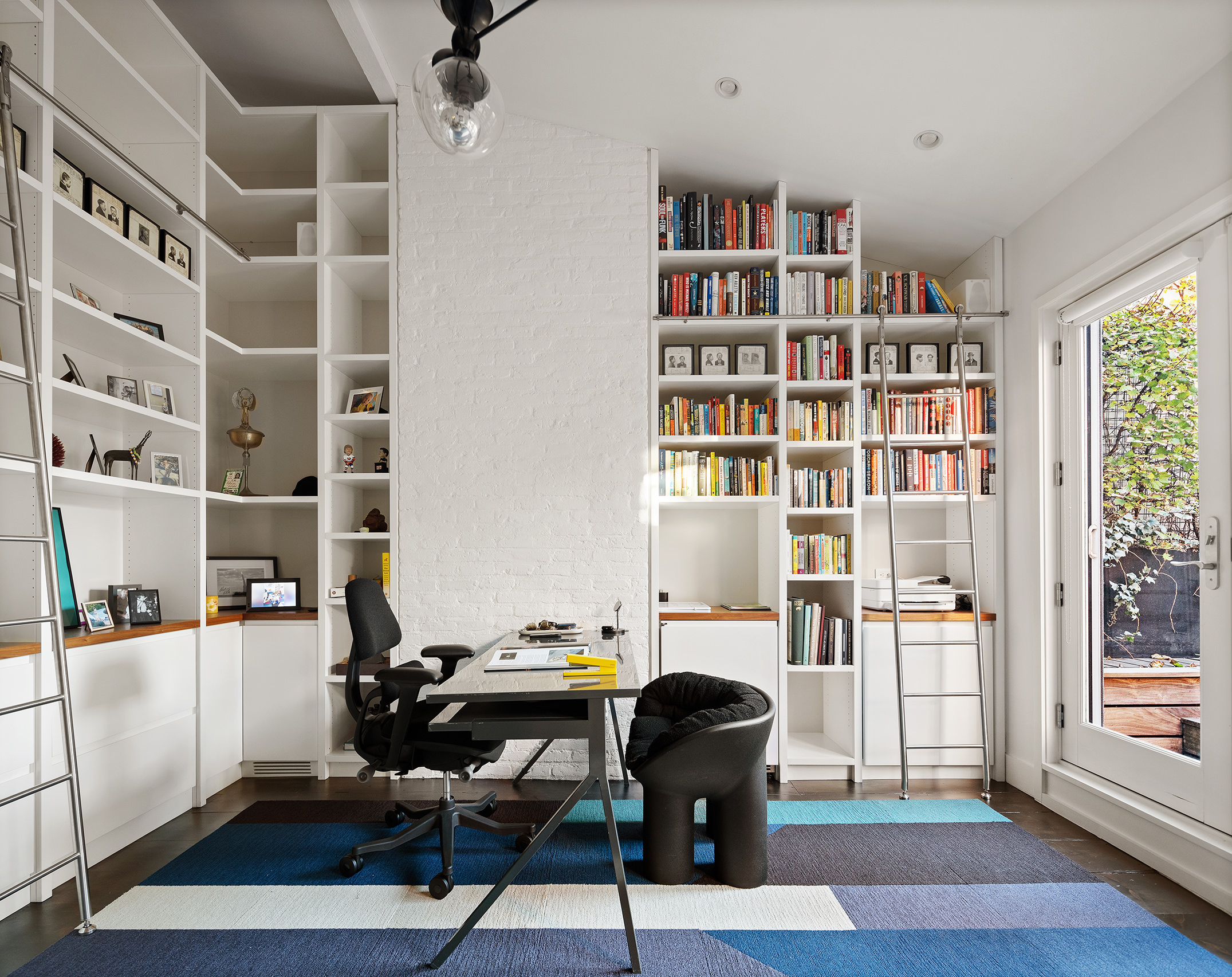 104 Willow Street Brooklyn, NY 11201 - Photo 16 of 27 a view of a workspace with furniture and a bookshelf