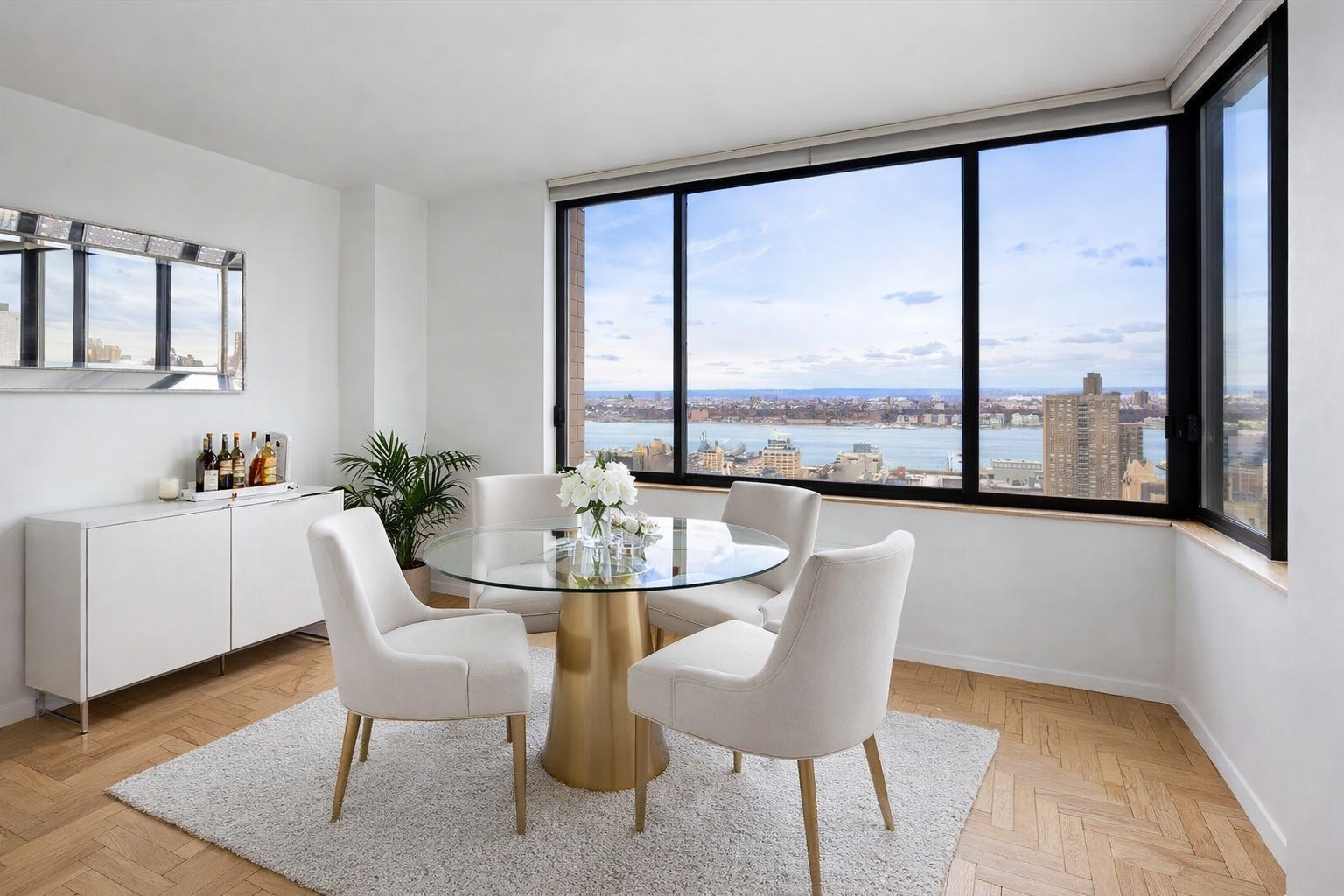 350 West 50th Street, Unit PH3C Manhattan, NY 10019 - Photo 6 of 17 a view of a dining room with furniture window and wooden floor