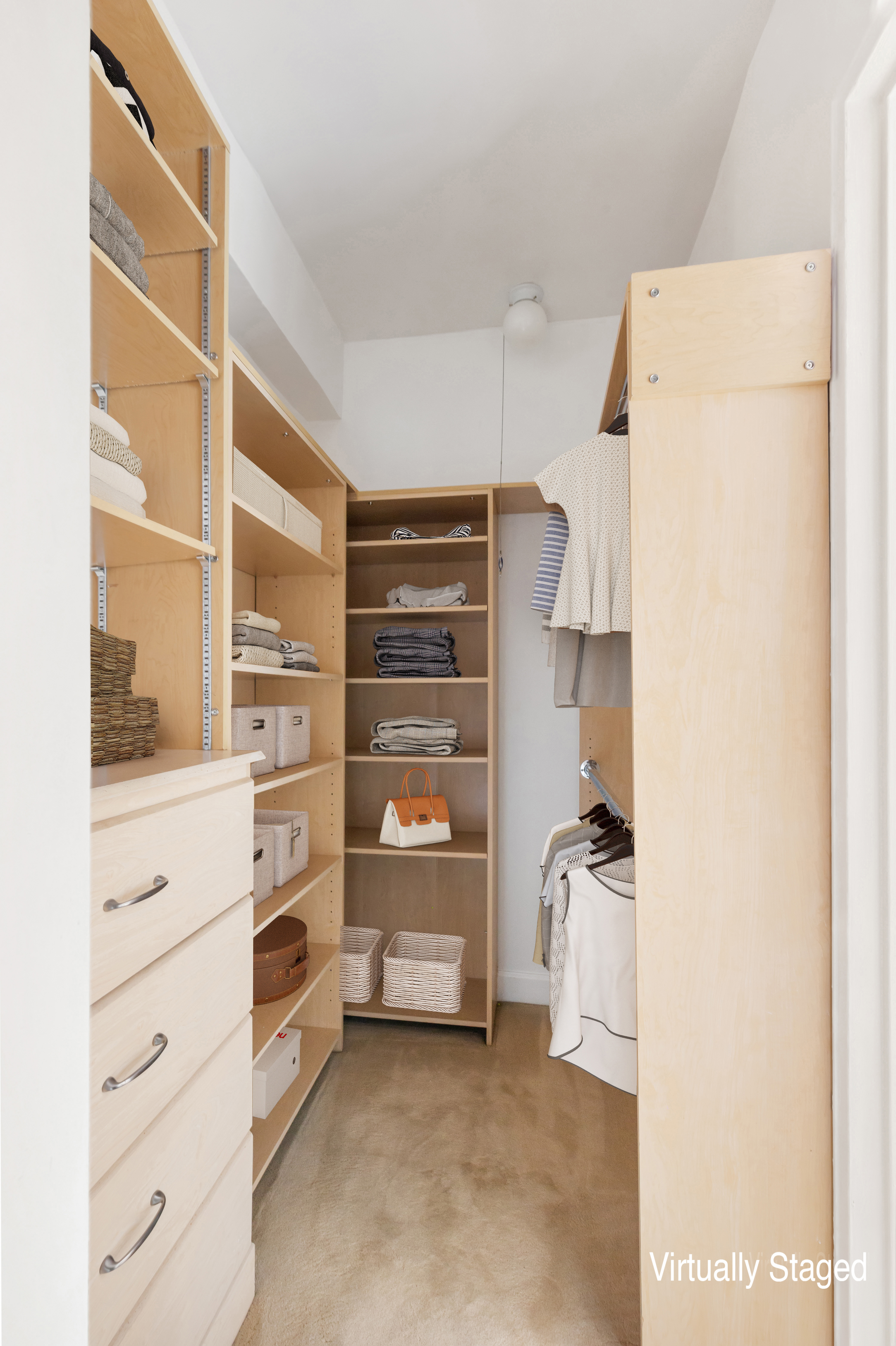 181 East 73rd Street, Unit 9G Manhattan, NY 10021 - Photo 16 of 17 a view of walk in closet with clothes and shoes