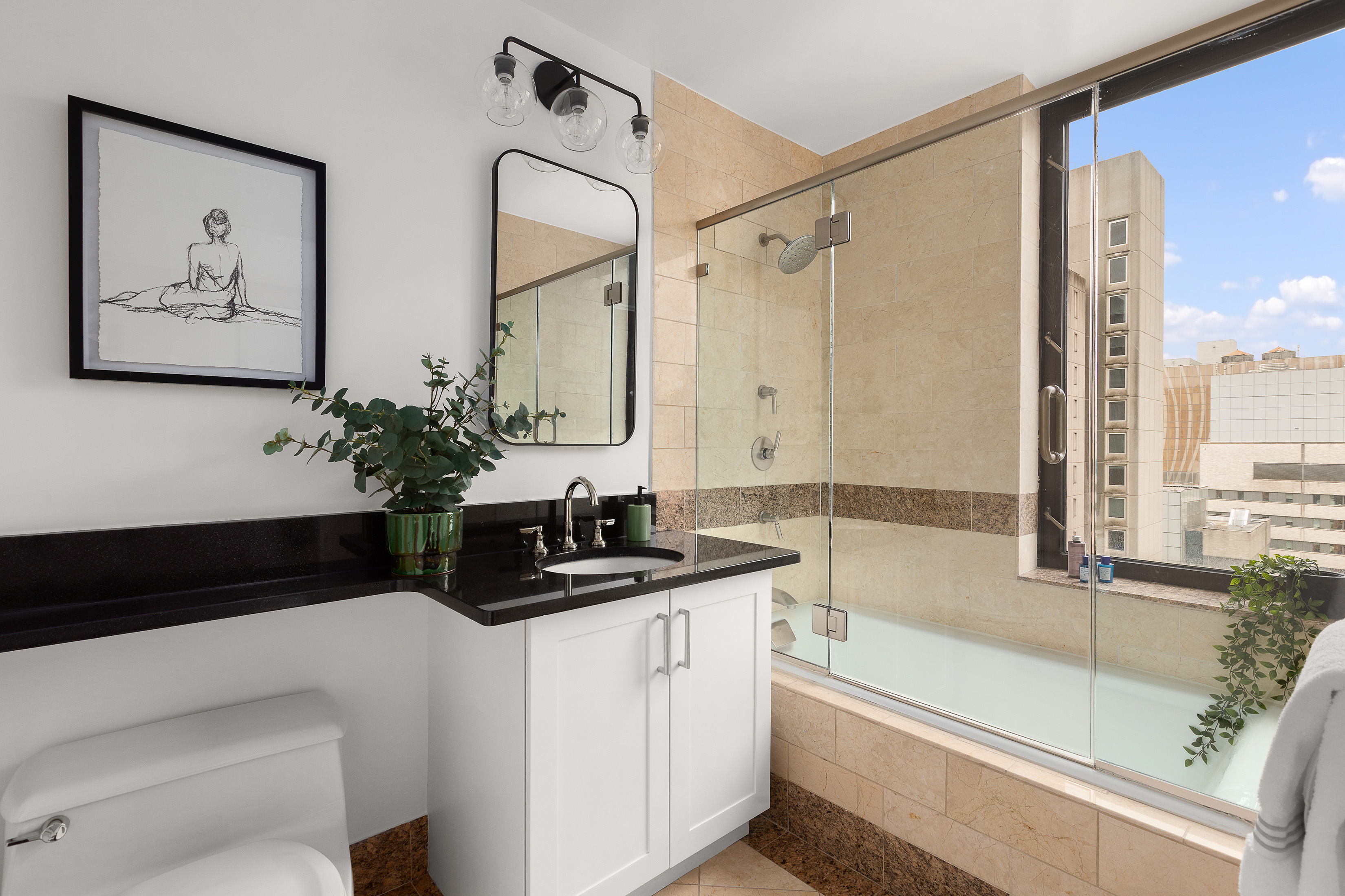 422 East 72nd Street, Unit 27C Manhattan, NY 10021 - Photo 18 of 25 a bathroom with a granite countertop sink a toilet and a bathtub