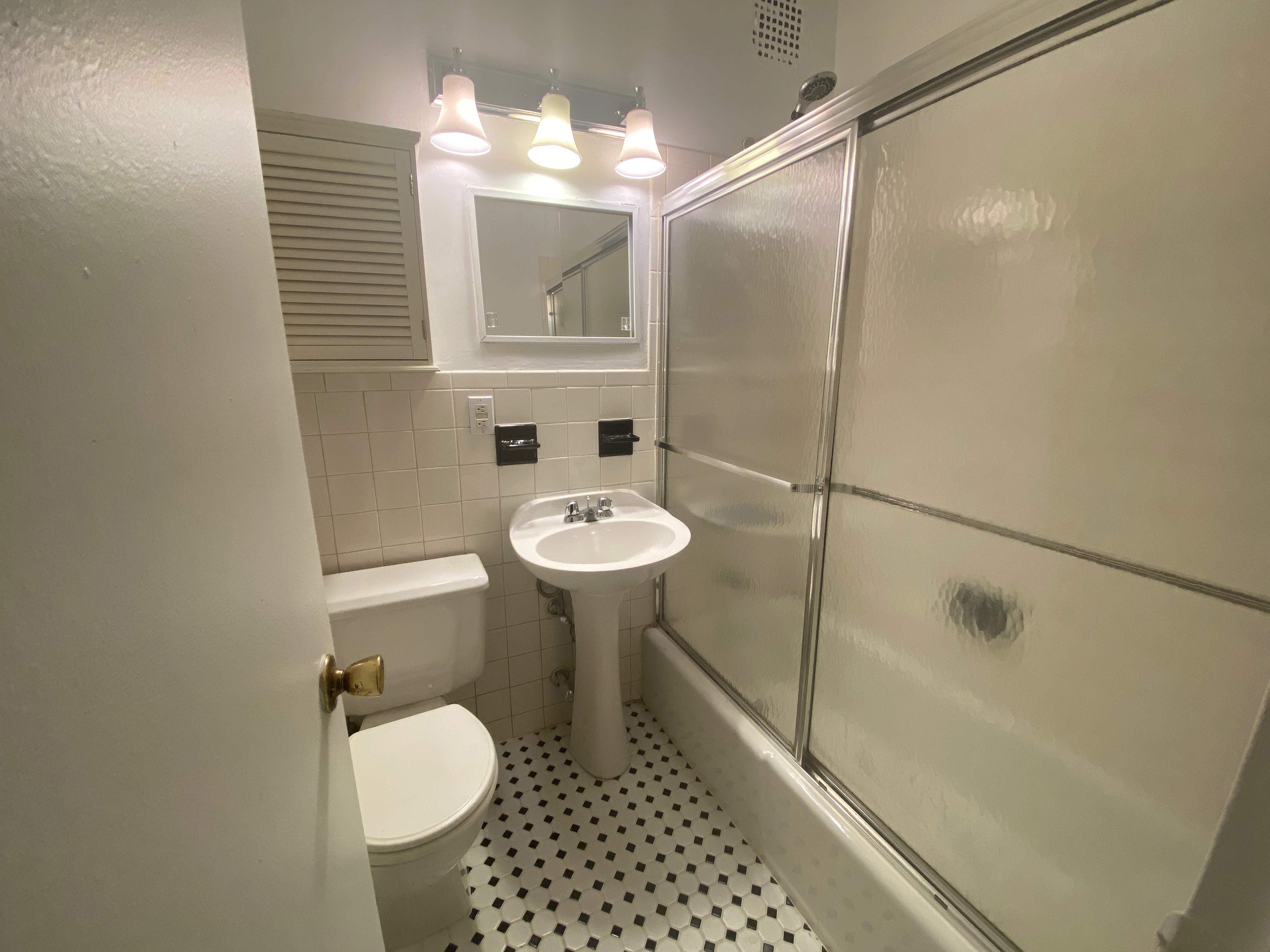 1240 Lexington Avenue, Unit 34 Manhattan, NY 10028 - Photo 6 of 11 a bathroom with a sink toilet a mirror and shower