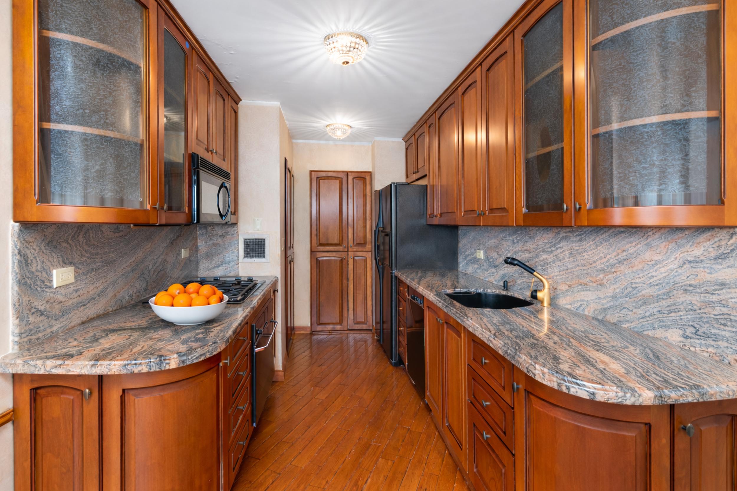 112-01 Queens Boulevard, Unit 17H Queens, NY 11375 - Photo 7 of 26 a kitchen with stainless steel appliances granite countertop a sink stove and refrigerator