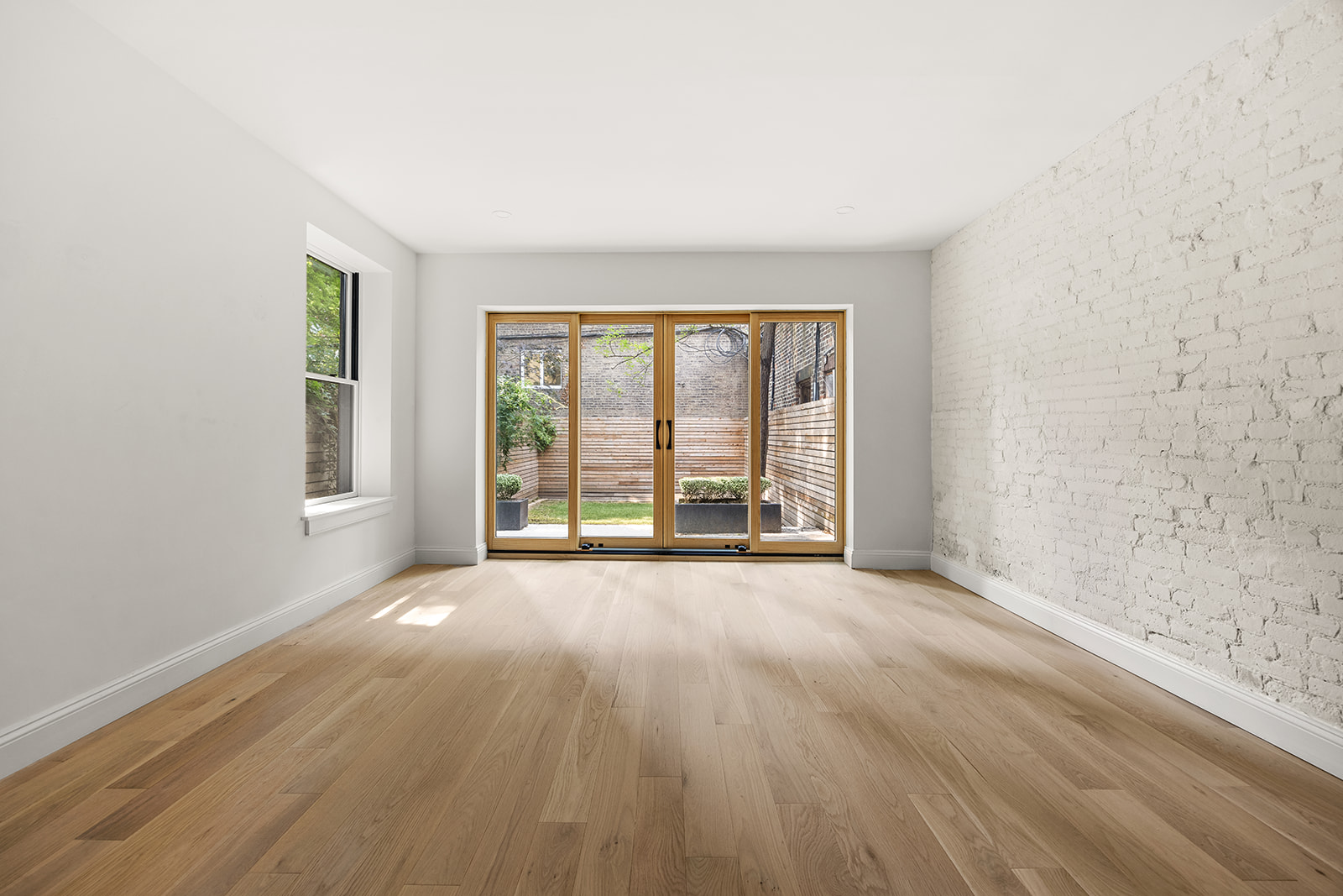 84 6th Avenue, Unit 1 Brooklyn, NY 11217 - Photo 2 of 22 wooden floor in an empty room with a window