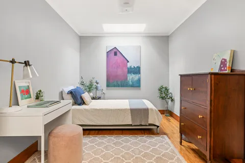 a bedroom with a bed and a dresser