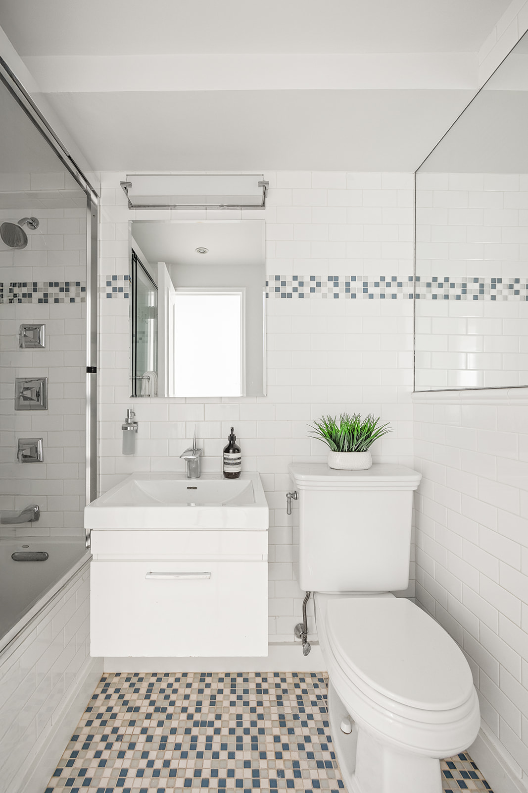 69 West 9th Street, Unit 2B Manhattan, NY 10011 - Photo 16 of 18 a bathroom with a sink a toilet and shower