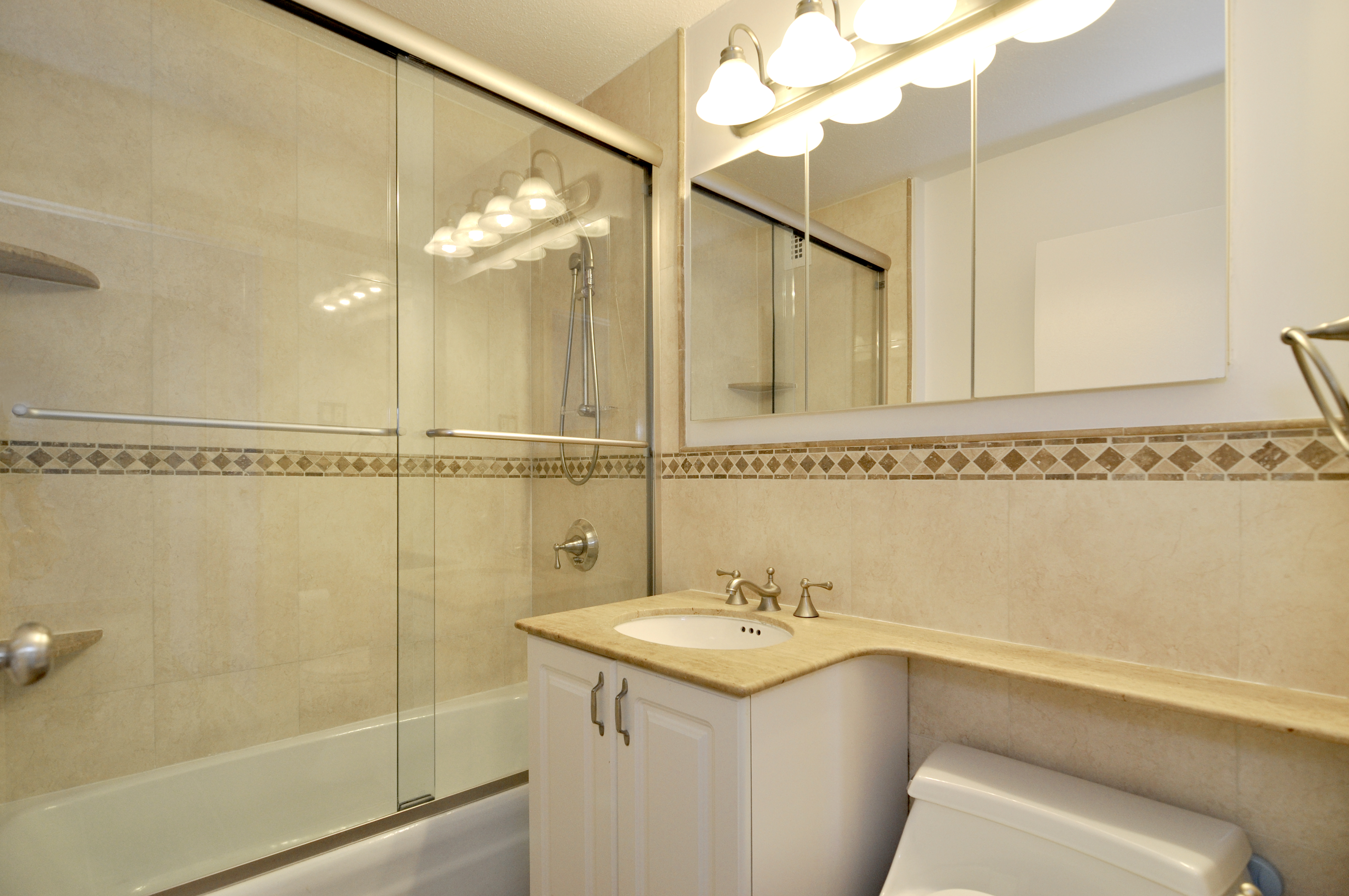 1623 3rd Avenue, Unit 25C Manhattan, NY 10128 - Photo 6 of 12 a bathroom with a sink and a mirror