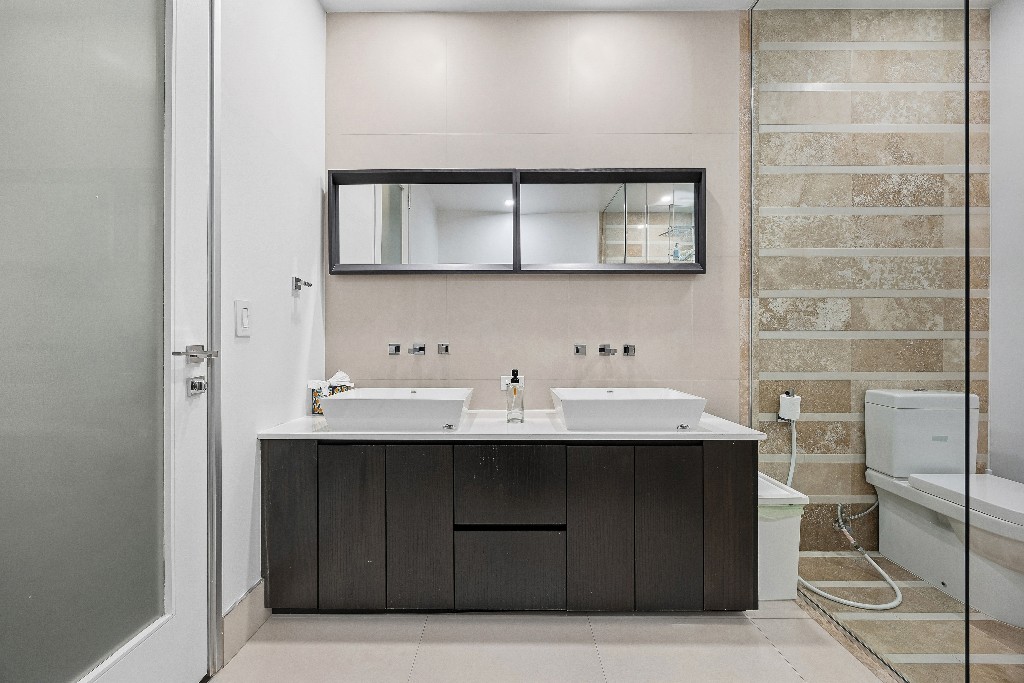 111 Fulton Street, Unit 824 Manhattan, NY 10038 - Photo 19 of 35 a bathroom with a sink and a mirror