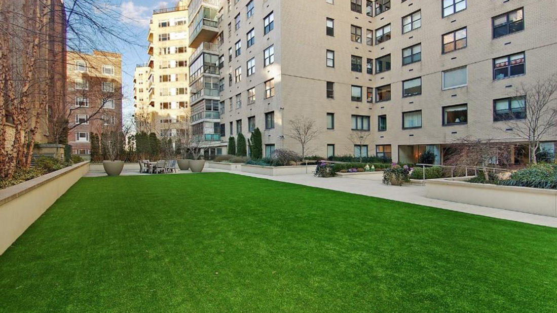 180 East End Avenue, Unit 1C Manhattan, NY 10128 - Photo 16 of 19 a building with garden and bench