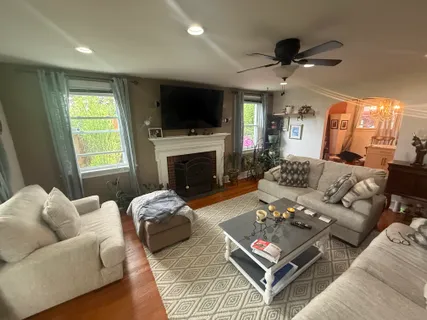 a living room with furniture a flat screen tv and a fireplace