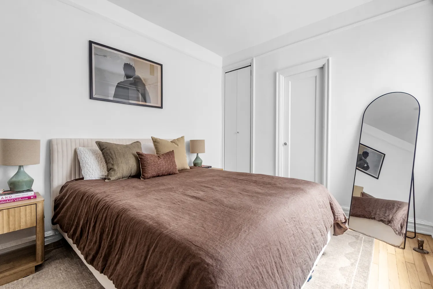 a bedroom with bed and cupboard