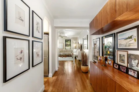 a view of a living room with furniture and wooden floor