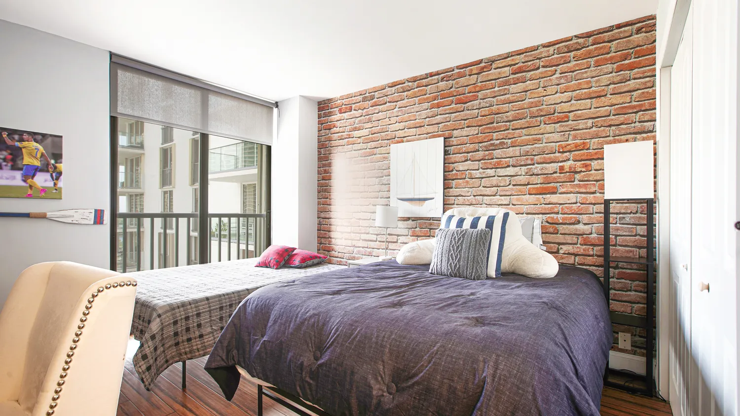 a bedroom with a bed and a large window