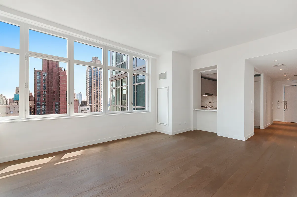 305 East 51st Street, Unit 14F Manhattan, NY 10022 - Photo 2 of 19 a view of empty room with windows