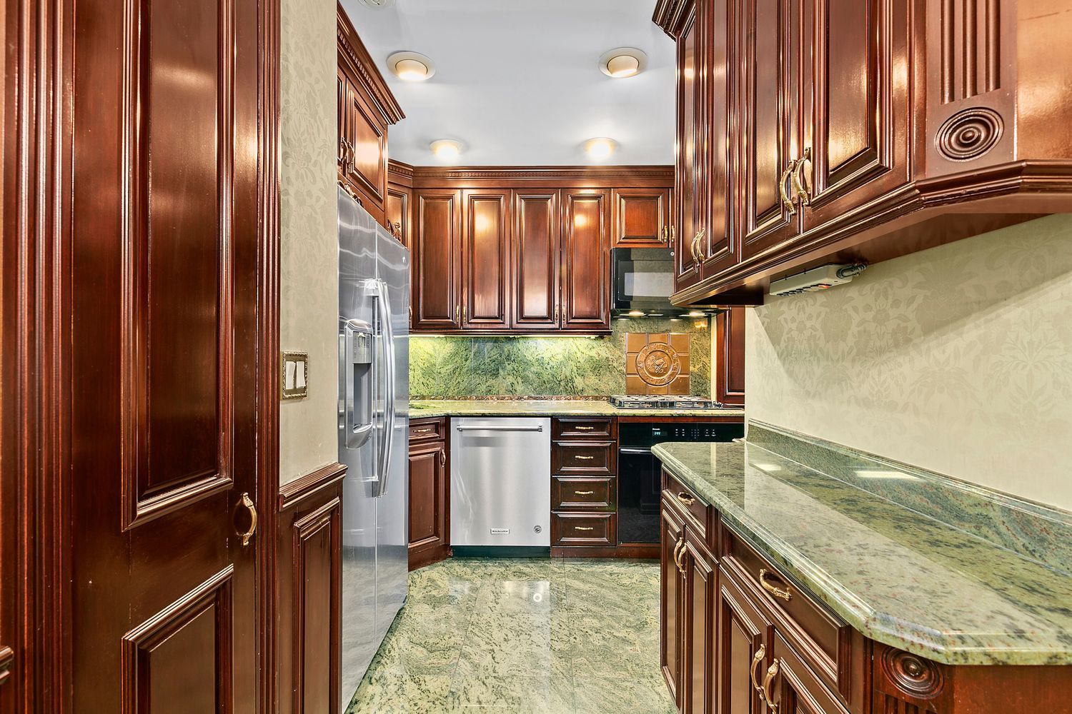 530 East 76th Street, Unit 10H Manhattan, NY 10021 - Photo 7 of 26 a kitchen with stainless steel appliances granite countertop a refrigerator and a stove