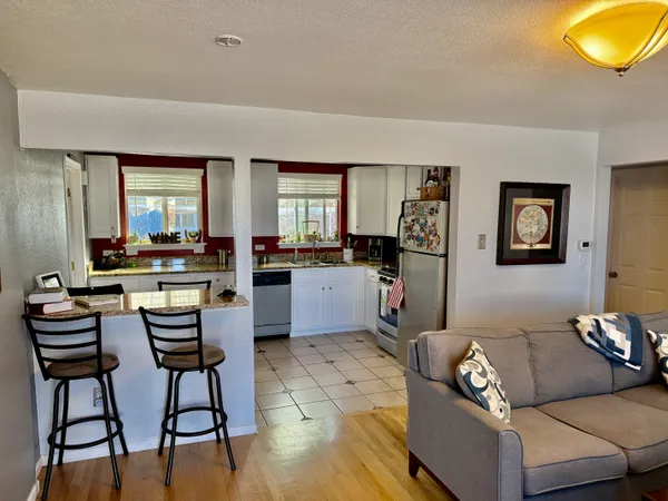 a living room with furniture and large windows