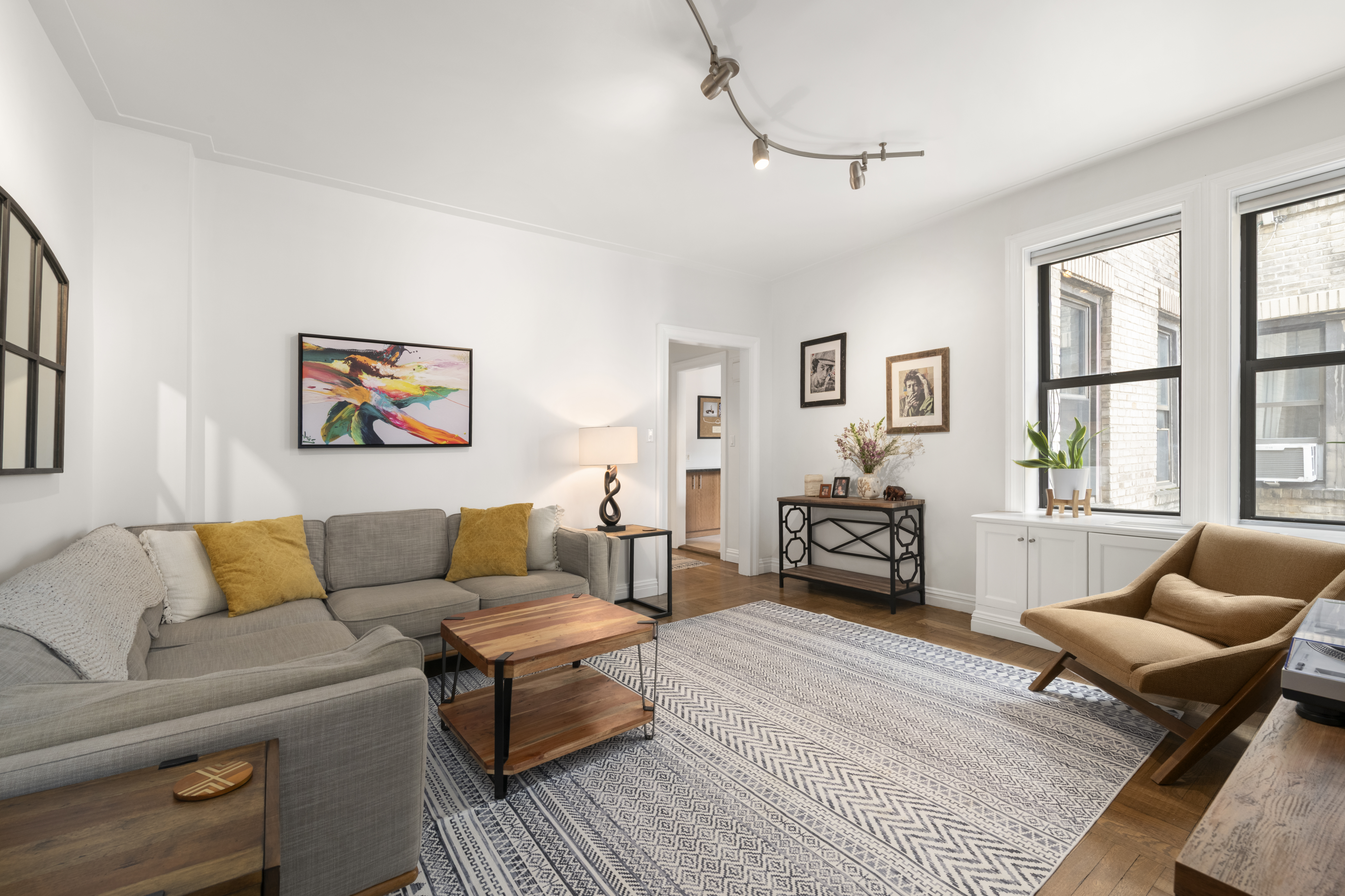 222 East 82nd Street, Unit 5E Manhattan, NY 10028 - Photo 1 of 10 a living room with furniture and a couch