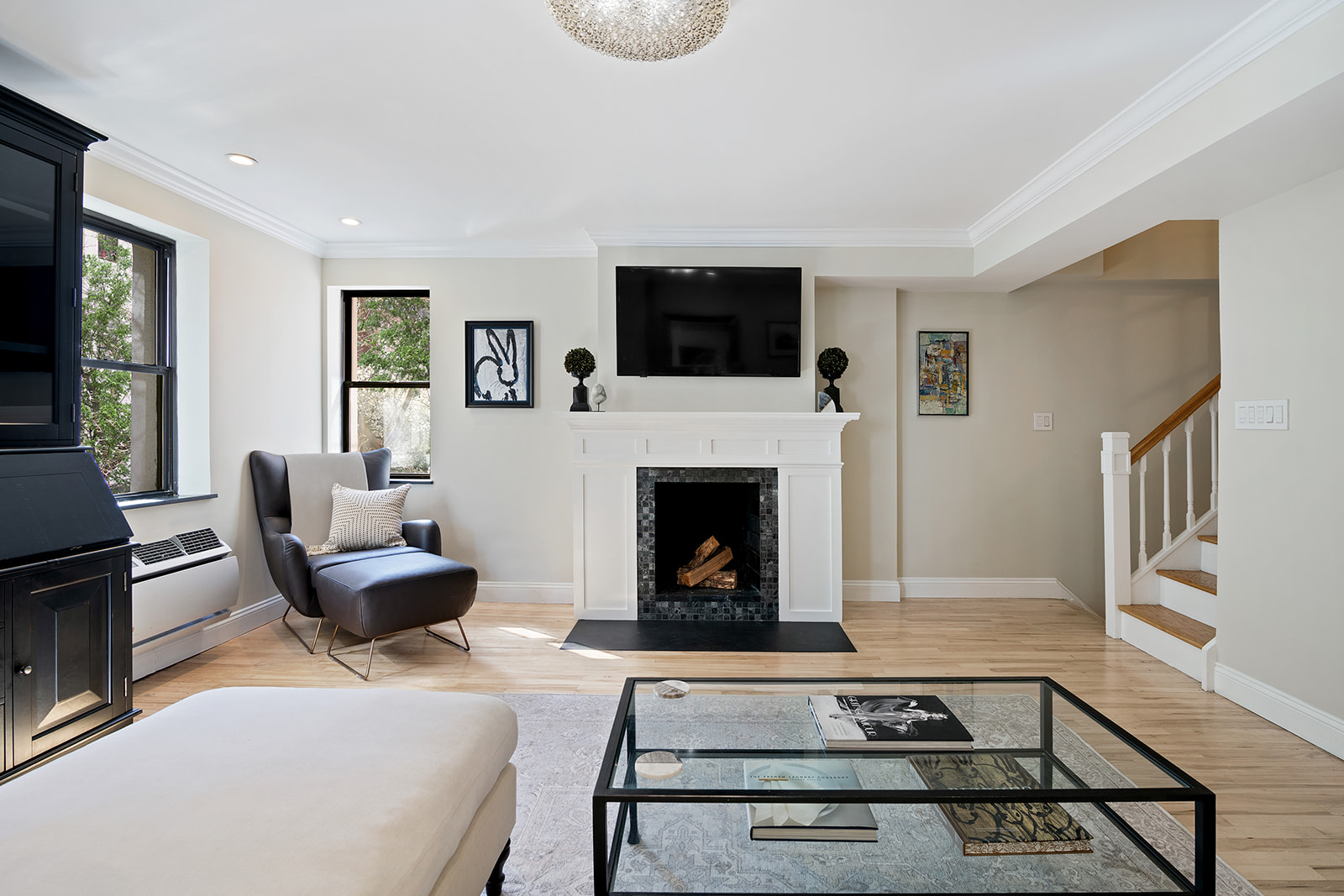 a living room with furniture a flat screen tv and a fireplace