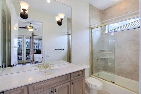 a spacious bedroom with a bed and a chandelier