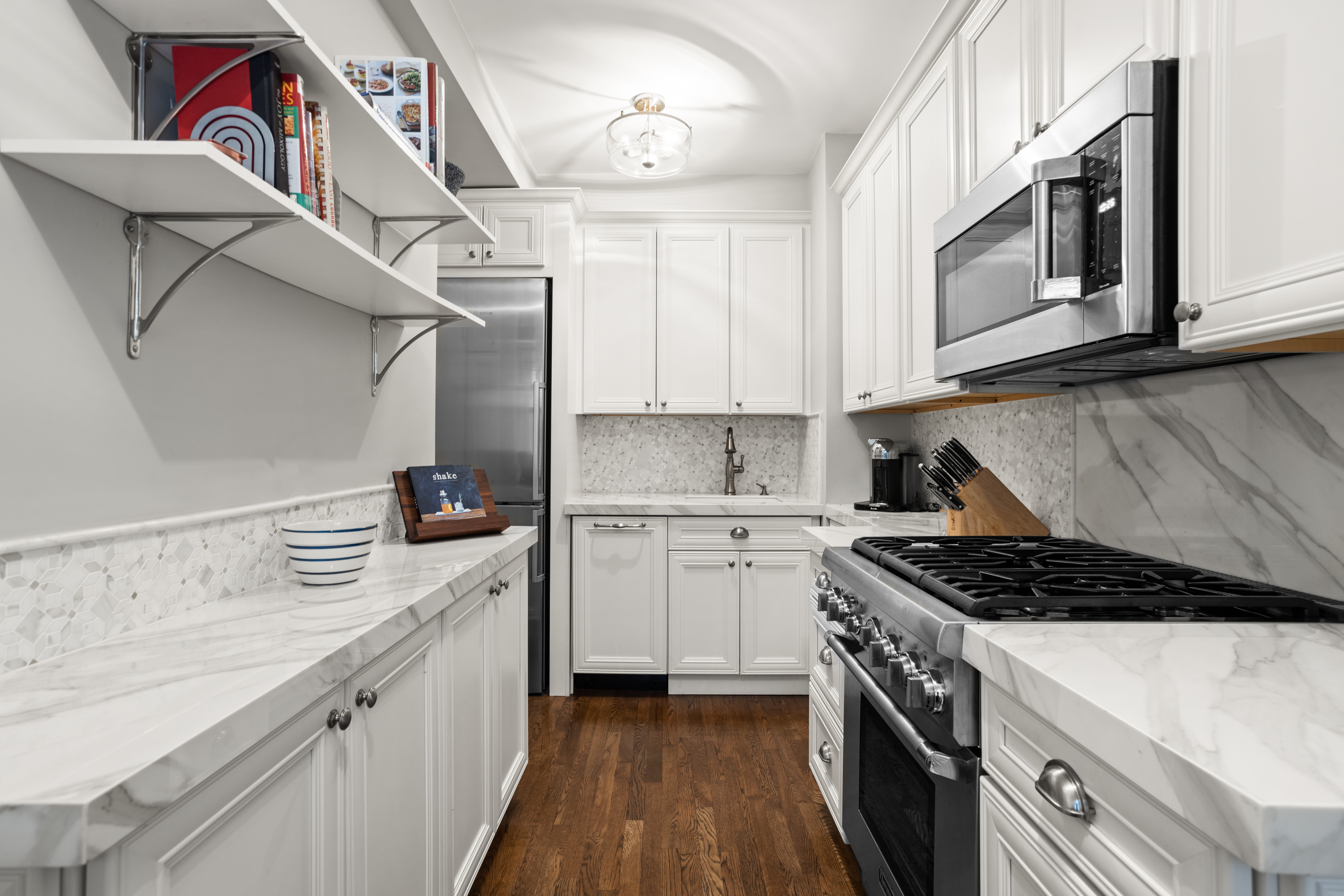 107 West 86th Street, Unit 3H Manhattan, NY 10024 - Photo 3 of 7 a kitchen with stainless steel appliances granite countertop a sink stove and cabinets