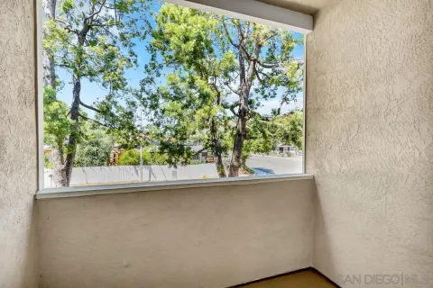 a room with a bed and a large window