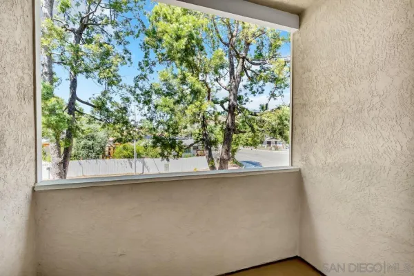 a room with a bed and a large window