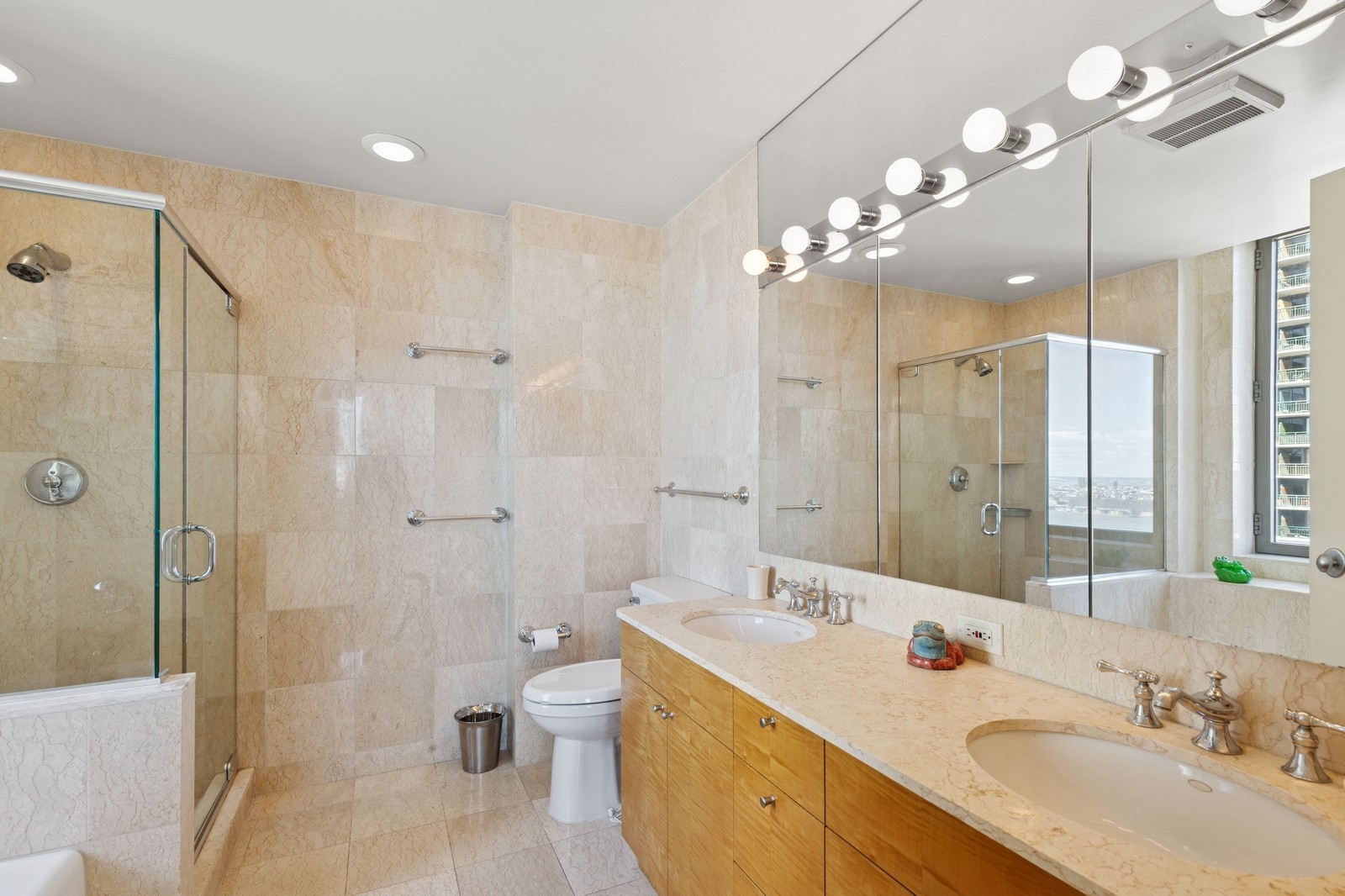 2 Columbus Avenue, Unit 35A Manhattan, NY 10023 - Photo 7 of 13 a bathroom with a double vanity sink mirror and toilet