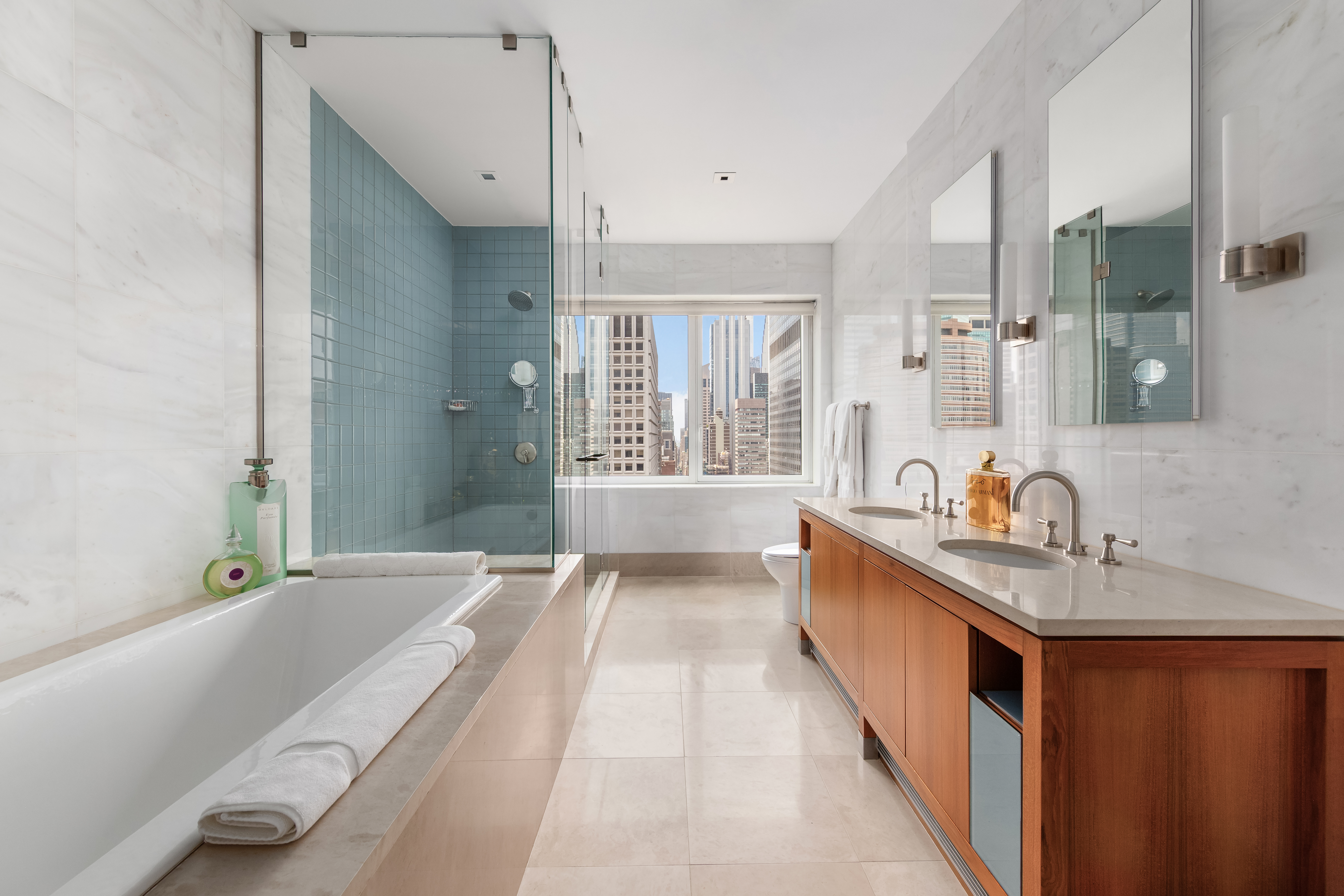 300 East 55th Street, Unit PHC Manhattan, NY 10022 - Photo 11 of 21 a spacious bathroom with a granite countertop tub sink a mirror and shower