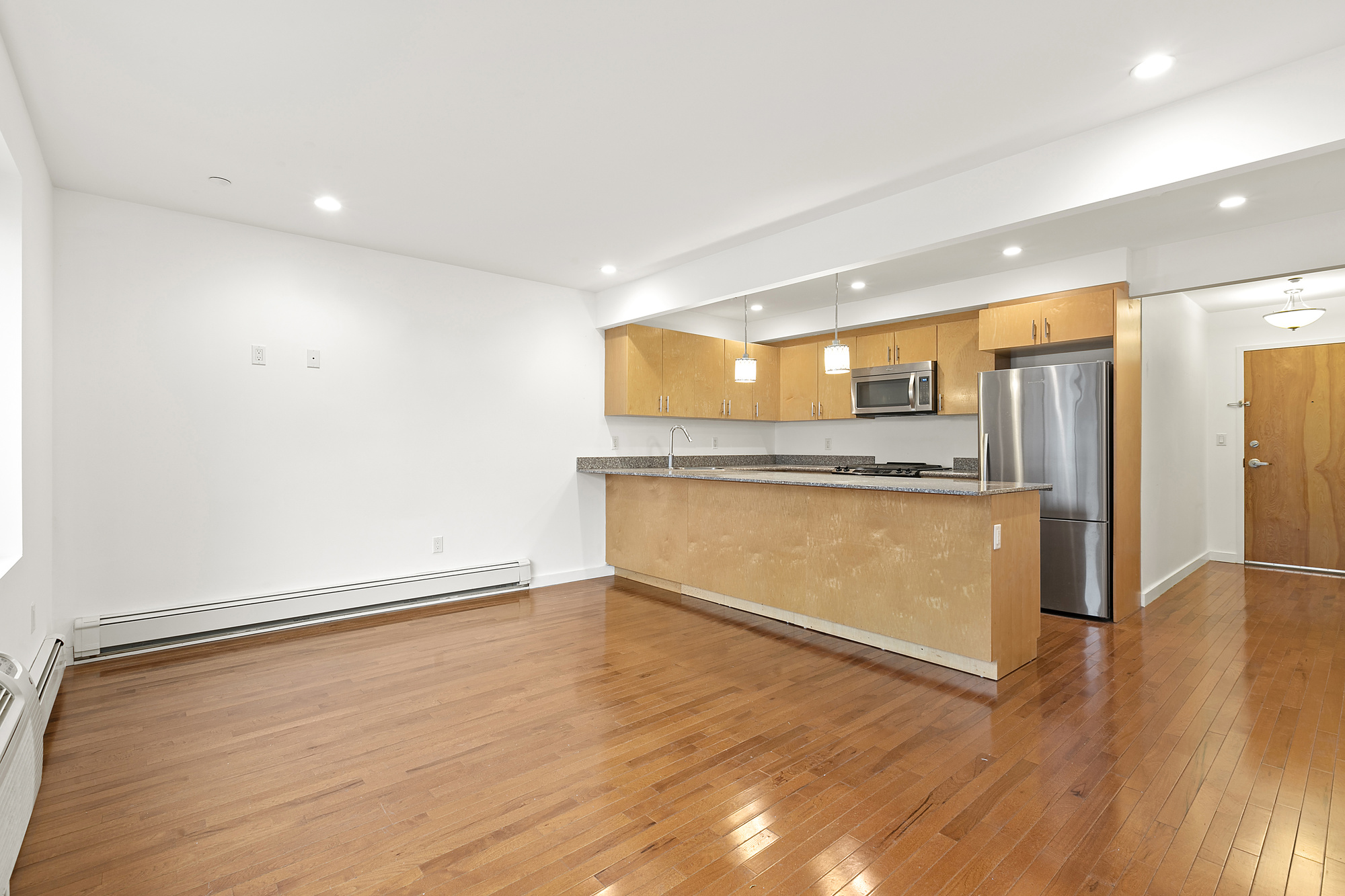 400 15th Street, Unit 2D Brooklyn, NY 11215 - Photo 3 of 8 a view of an empty room with wooden floor and a window