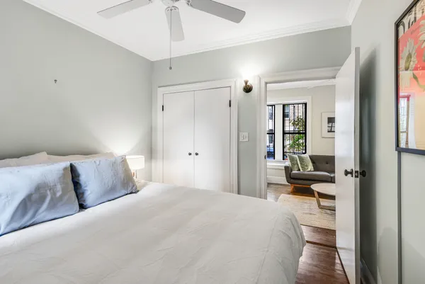a bedroom with a large bed and a chandelier