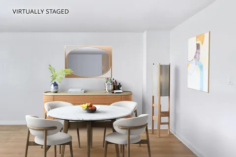 a view of a room with furniture and wooden floor