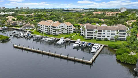 an aerial view of a house with a garden and lake view